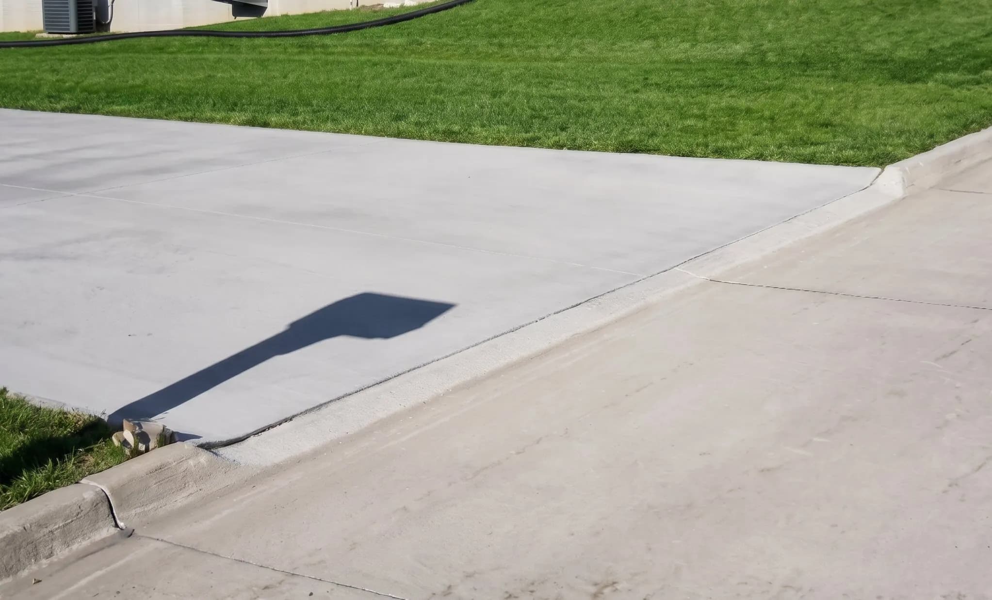 Completed curb grinding for driveway approach installation in Iowa