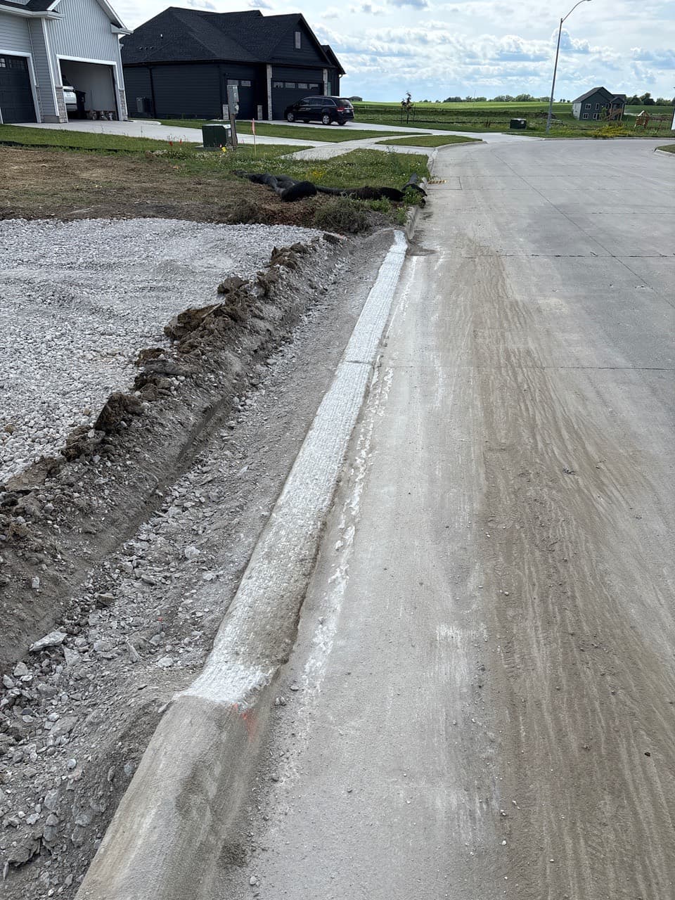 Curb grinding for a driveway approach on Westwood Drive in Huxley, Iowa